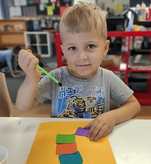 Child doing arts and crafts at day care