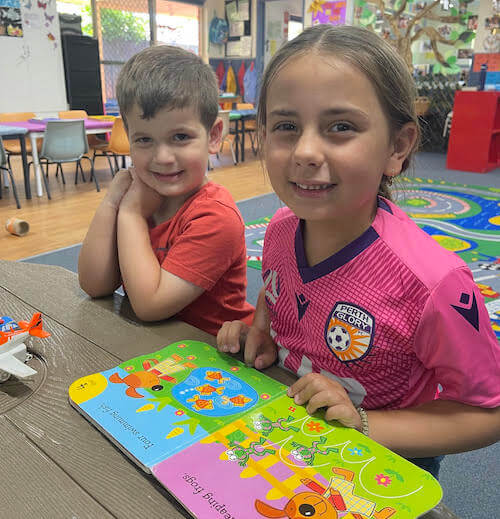 Children reading together at Marangaroo day care centre